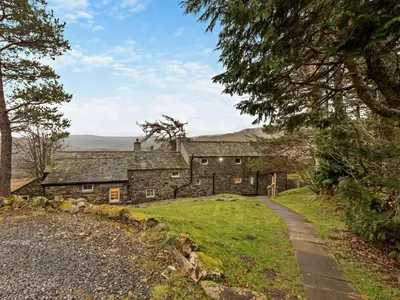 an old stone house with a path leading to it at 3 Bed in Penrith oc-sz247 in Dockray