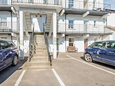 two cars parked in a parking lot in front of a building at 2 Bed in Keswick SZ027 in Keswick