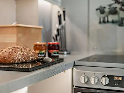 a loaf of bread on a cutting board in a kitchen at 2 Bed in Keswick SZ027 in Keswick