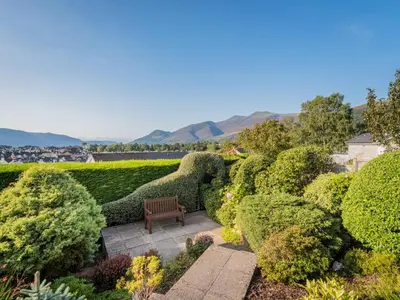 a bench sitting in the middle of a garden at 1 Bed in Keswick oc-sz437 in Keswick