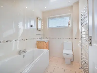 a bathroom with a tub and a toilet and a sink at 1 Bed in Keswick oc-sz437 in Keswick