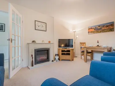 a living room with a blue couch and a fireplace at 1 Bed in Keswick oc-sz437 in Keswick