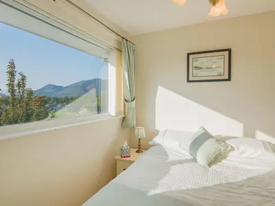a bedroom with a bed and a large window at 1 Bed in Keswick oc-sz437 in Keswick