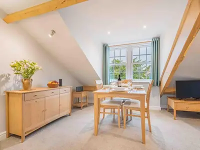 a dining room with a table and a tv at 2 Bed in Keswick SZ494 in Keswick