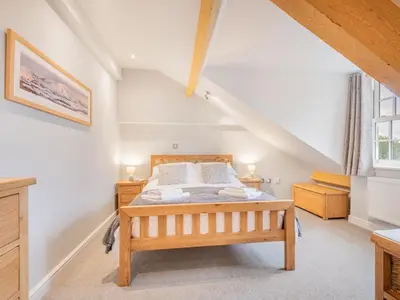 a bedroom with a wooden bed in a attic at 2 Bed in Keswick SZ494 in Keswick
