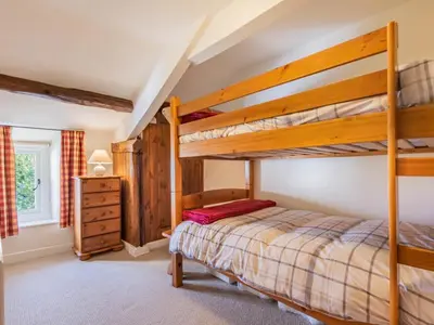 a bedroom with a bunk bed and a dresser at 2 Bed in Keswick oc-sz378 in Portinscale