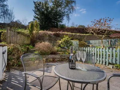 a table with a bottle of wine and two glasses at 2 Bed in Keswick oc-sz378 in Portinscale