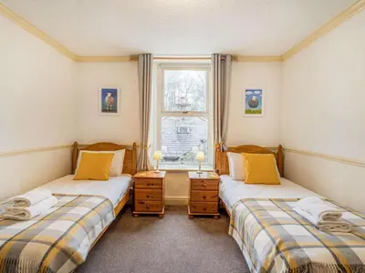 two twin beds in a room with a window at 2 Bed in Holmrook oc-sz464 in Beckfoot