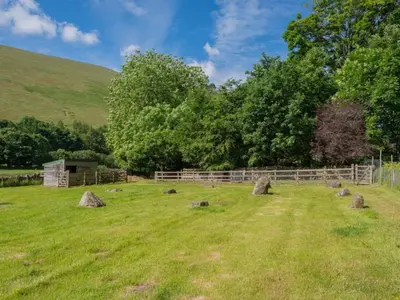 a field with a fence and rocks in the grass at 2 Bed in Penrith oc-sz218 in Mosedale