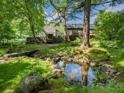 a house with a pond in the yard at 2 Bed in Penrith oc-sz218 in Mosedale