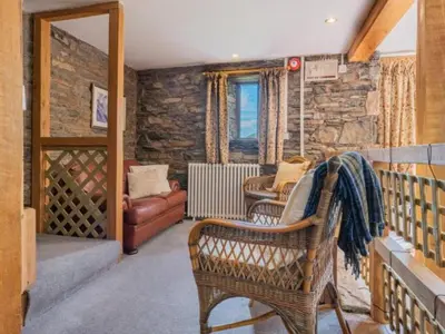 a living room with a chair and a couch at 2 Bed in Penrith oc-sz092 in Mosedale