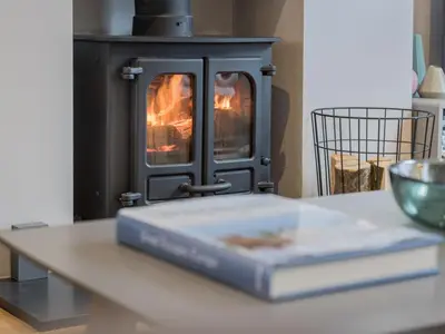 a book sitting on a table in front of a stove at 3 Bed in Keswick oc-sz029 in Keswick