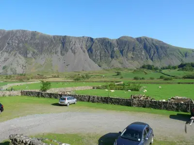 a car parked in front of a field with sheep at 2 Bed in Wasdale Head oc-sz551 in Nether Wasdale