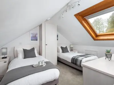 two beds in a white room with a window at 3 Bed in Keswick oc-sz337 in Keswick