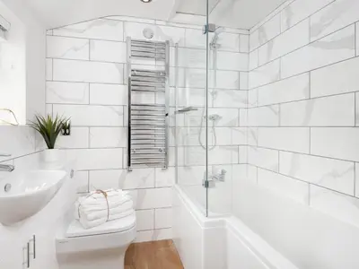 a white bathroom with a tub and a toilet and a sink at 3 Bed in Keswick oc-sz337 in Keswick