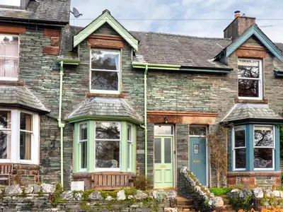 a brick house with a blue door at 3 Bed in Keswick oc-sz337 in Keswick
