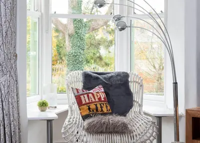 a pillow on a wicker chair in front of a window at 3 Bed in Keswick oc-sz337 in Keswick