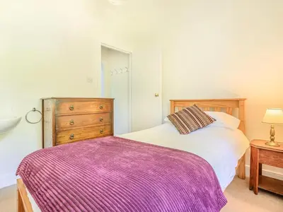 a bedroom with a bed and a wooden dresser at 3 Bed in Borrowdale SZ234 in Rosthwaite