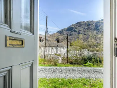 a door to a house with a view of a mountain at 3 Bed in Borrowdale SZ234 in Rosthwaite