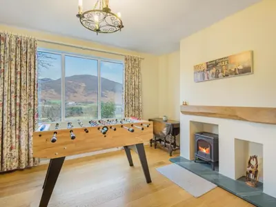 a living room with a pool table and a fireplace at 4 Bed in Newlands Valley SZ204 in Braithwaite