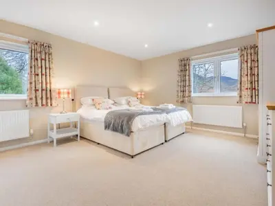 a bedroom with a bed and two windows at 4 Bed in Newlands Valley SZ204 in Braithwaite