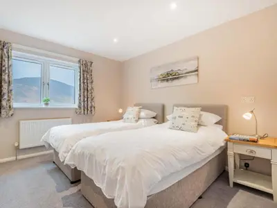 two beds in a bedroom with a window at 4 Bed in Newlands Valley SZ204 in Braithwaite