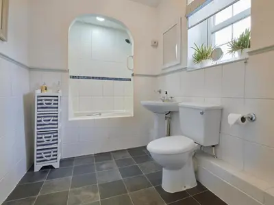 a bathroom with a toilet and a sink and a mirror at 2 Bed in Workington oc-sz323 in Camerton