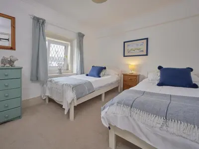 a bedroom with two beds and a window at 2 Bed in Workington oc-sz323 in Camerton