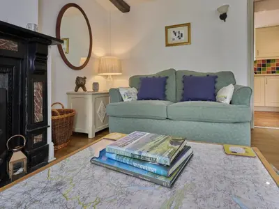 a living room with a couch and a pile of books at 2 Bed in Workington oc-sz323 in Camerton
