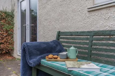 a blanket and a tray of food on a bench at 3 Bed in Keswick oc-84638 in Keswick