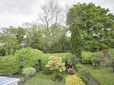 a garden with green bushes and trees and trees at 2 Bed in Keswick oc-sz188 in Keswick