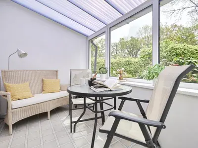 a conservatory with a table and chairs and a window at 2 Bed in Keswick oc-sz188 in Keswick