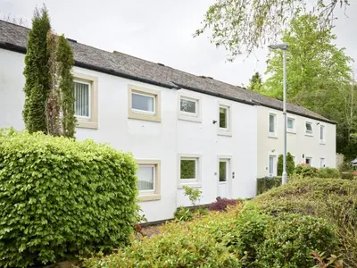 a white house with bushes in front of it at 2 Bed in Keswick oc-sz188 in Keswick