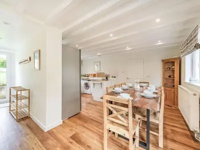a kitchen and dining room with a table and chairs at 3 Bed in Keswick oc-sz335 in Portinscale