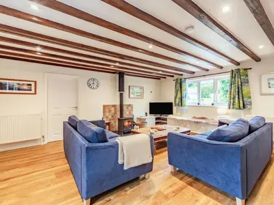 a living room with two blue couches and a tv at 3 Bed in Keswick oc-sz335 in Portinscale