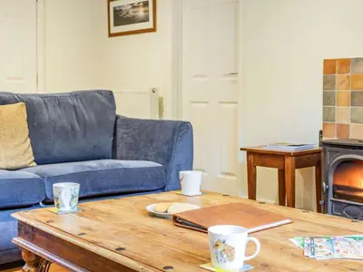 a living room with a blue couch and a coffee table at 3 Bed in Keswick oc-sz335 in Portinscale