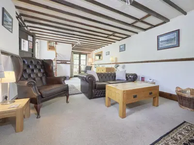 a living room with leather furniture and a table at 1 Bed in Eskdale SZ471 in Beckfoot