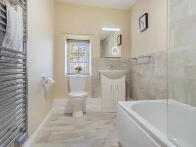 a bathroom with a toilet and a sink and a tub at 2 Bed in Keswick oc-sz199 in Applethwaite