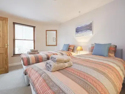 a bedroom with two beds and a window at 2 Bed in Keswick oc-sz279 in Keswick