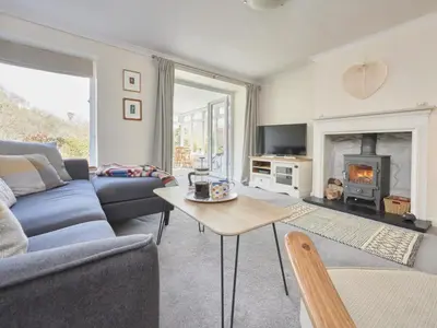 a living room with a blue couch and a fireplace at 3 Bed in Keswick oc-sz533 in Braithwaite