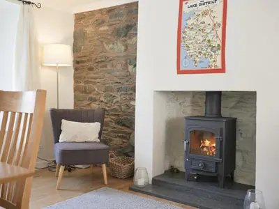 a living room with a stove and a chair at 3 Bed in Keswick oc-sz533 in Braithwaite