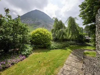 a garden with a mountain in the background at 2 Bed in Cockermouth oc-sz588 in Buttermere