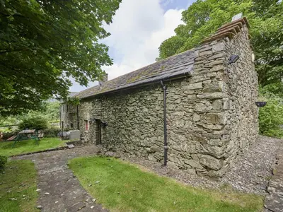 an old stone house with a stone wall at 2 Bed in Cockermouth oc-sz588 in Buttermere