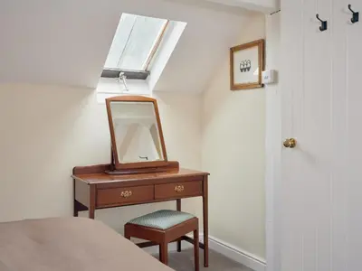 a mirror on a dresser next to a bed at 2 Bed in Cockermouth oc-sz588 in Buttermere