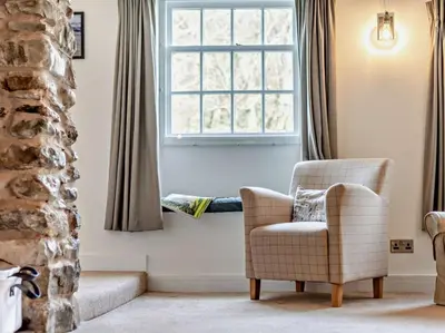 a living room with a chair and a window at 3 Bed in Braithwaite SZ174 in Braithwaite