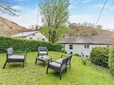 a group of chairs and a table in a yard at 3 Bed in Braithwaite SZ174 in Braithwaite