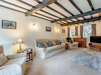 a living room with couches and a piano at 3 Bed in Braithwaite SZ174 in Braithwaite