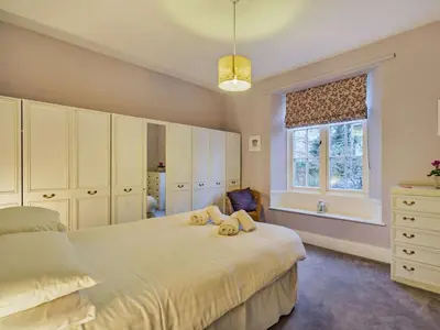 a bedroom with a large bed and a window at 4 Bed in Ambleside oc-85294 in Grasmere