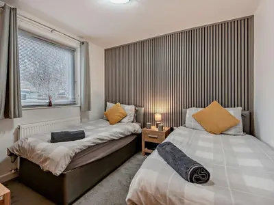 a bedroom with two beds next to a window at 2 Bed in Keswick 86001 in Keswick