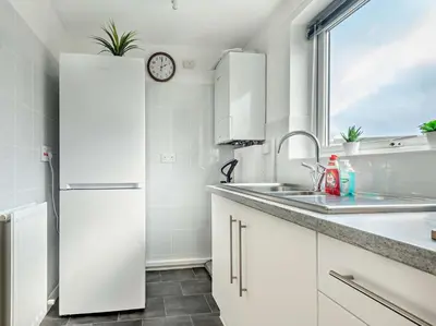 a white kitchen with a refrigerator and a sink at 2 Bed in Keswick 86001 in Keswick